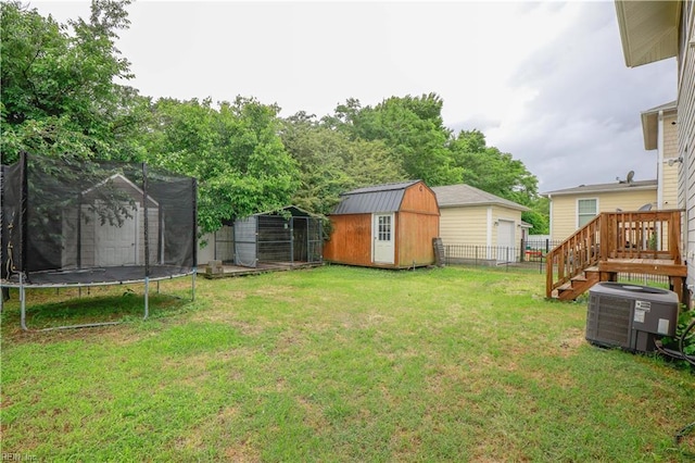 1060 Fairgrounds Ln, Suffolk, VA 23434 - view of yard with a trampoline, a shed, central air condition unit, an outdoor structure, and a garage