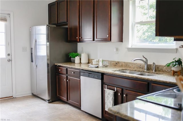 1060 Fairgrounds Ln, Suffolk, VA 23434 - kitchen featuring stainless steel appliances, a sink, light stone counters, and dark brown cabinetry