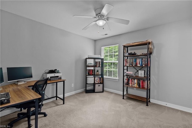 office with carpet flooring, baseboards, and a ceiling fan