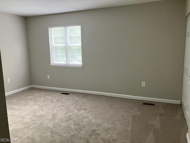 12765 Woodside Ln, Newport News, VA 23602 - spare room featuring carpet floors and baseboards