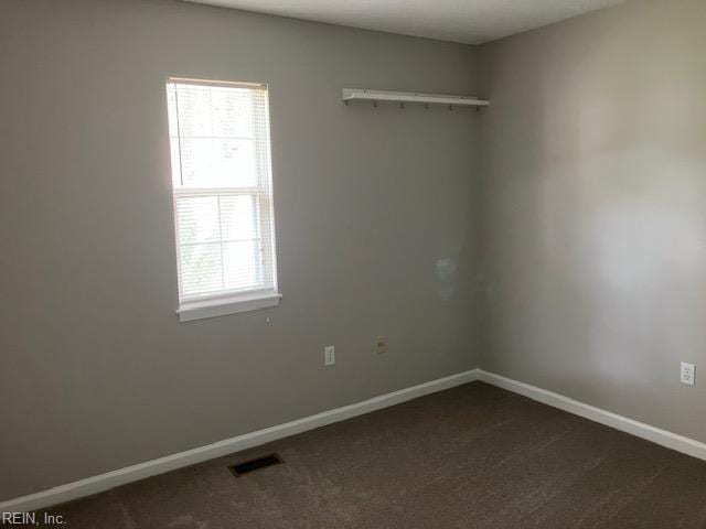 12765 Woodside Ln, Newport News, VA 23602 - spare room with healthy amount of natural light, dark carpet, and baseboards