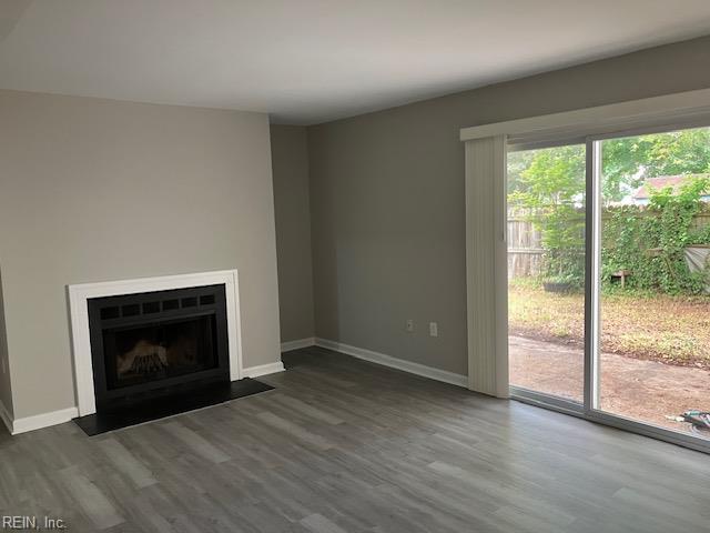 12765 Woodside Ln, Newport News, VA 23602 - unfurnished living room with wood finished floors, baseboards, and a fireplace