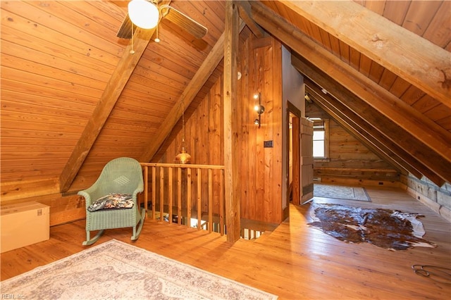 additional living space featuring wooden ceiling, wood-type flooring, wood walls, and a ceiling fan