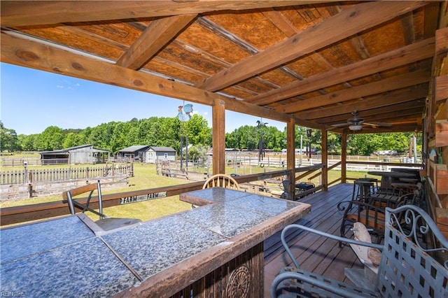 deck with fence and view of wooded area