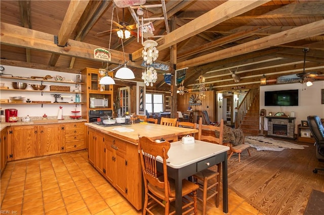 kitchen featuring a ceiling fan, white microwave, open shelves, wood ceiling, and oven
