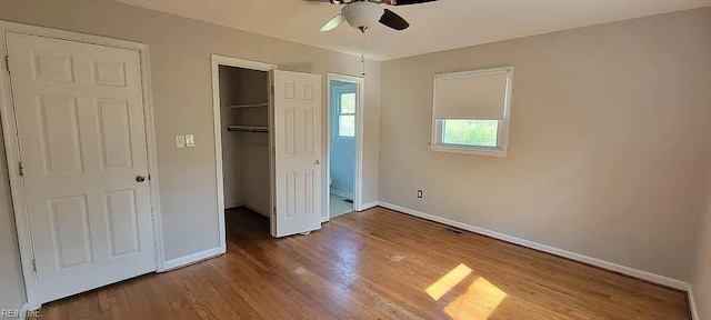 49 Church St, Poquoson, VA 23662 - unfurnished bedroom with baseboards, wood finished floors, a closet, and a ceiling fan