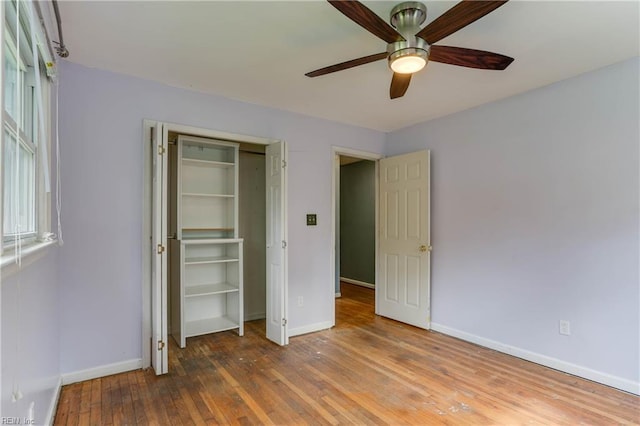 49 Church St, Poquoson, VA 23662 - unfurnished bedroom featuring baseboards, hardwood / wood-style floors, ceiling fan, and a closet