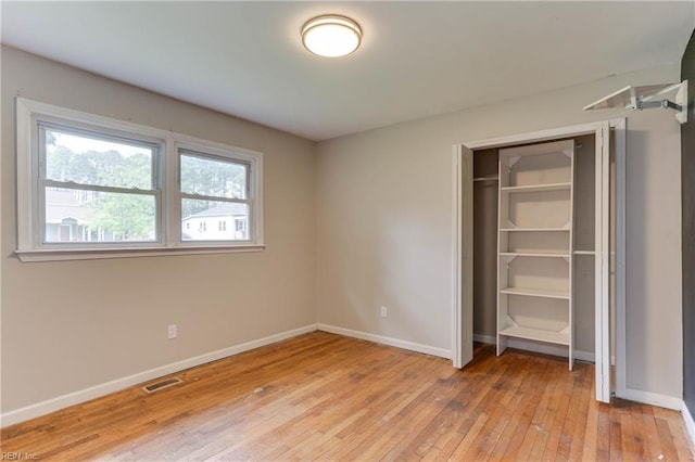 49 Church St, Poquoson, VA 23662 - unfurnished bedroom featuring light wood-style floors, baseboards, and a closet
