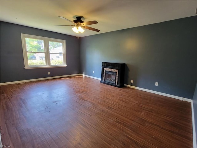 49 Church St, Poquoson, VA 23662 - unfurnished living room featuring a ceiling fan, a glass covered fireplace, dark wood finished floors, and baseboards