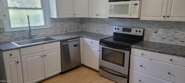 49 Church St, Poquoson, VA 23662 - kitchen featuring stainless steel appliances, a sink, and white cabinetry