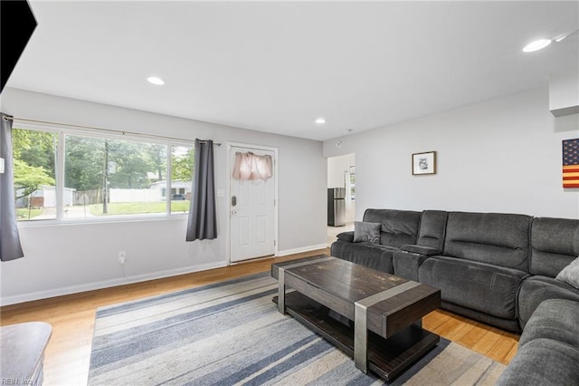 living area with wood finished floors, recessed lighting, and baseboards
