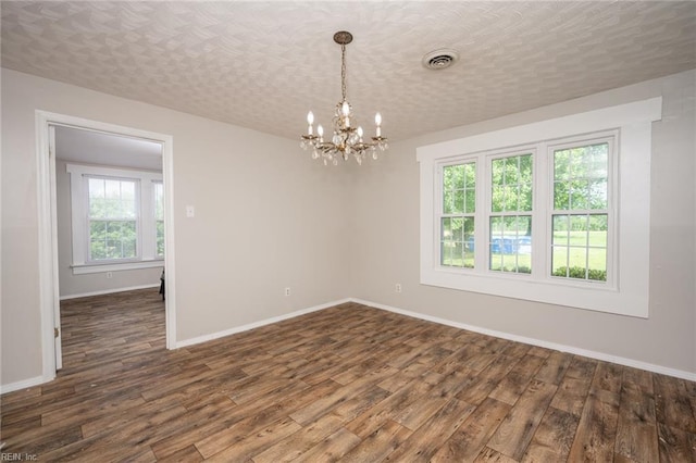 13542 Brink Rd, Emporia, VA 23847 - empty room featuring dark wood-style flooring, a chandelier, and baseboards