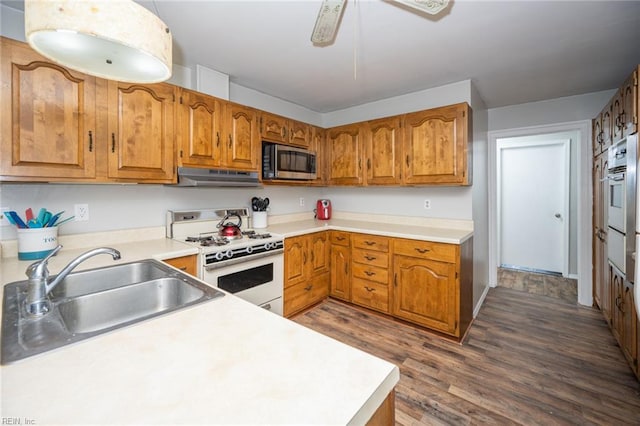13542 Brink Rd, Emporia, VA 23847 - kitchen with appliances with stainless steel finishes, a sink, under cabinet range hood, and brown cabinets