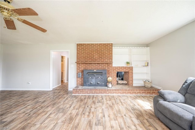 13542 Brink Rd, Emporia, VA 23847 - living area with wood finished floors, ceiling fan, baseboards, and a brick fireplace