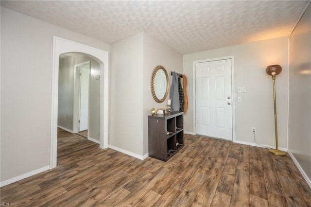 13542 Brink Rd, Emporia, VA 23847 - foyer featuring dark wood-style flooring, arched walkways, and baseboards