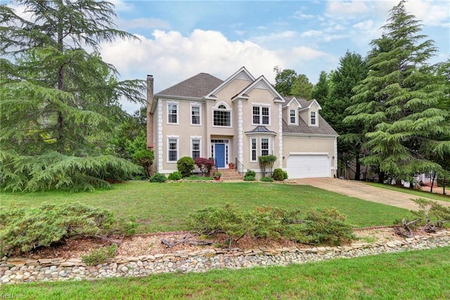 4901 Toddington Cir, Williamsburg, VA 23188 - colonial house featuring concrete driveway, a chimney, a front yard, an attached garage, and stucco siding