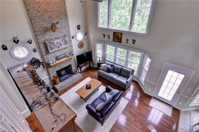 4901 Toddington Cir, Williamsburg, VA 23188 - living room with plenty of natural light, a high ceiling, a fireplace, and wood finished floors