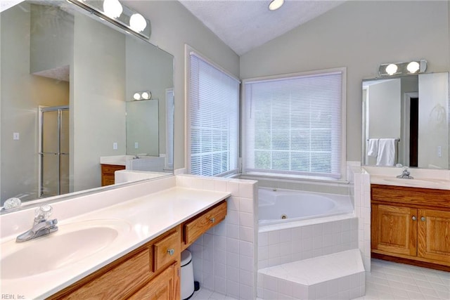 4901 Toddington Cir, Williamsburg, VA 23188 - full bathroom featuring vaulted ceiling, a tub with jets, two vanities, a shower stall, and tile patterned flooring