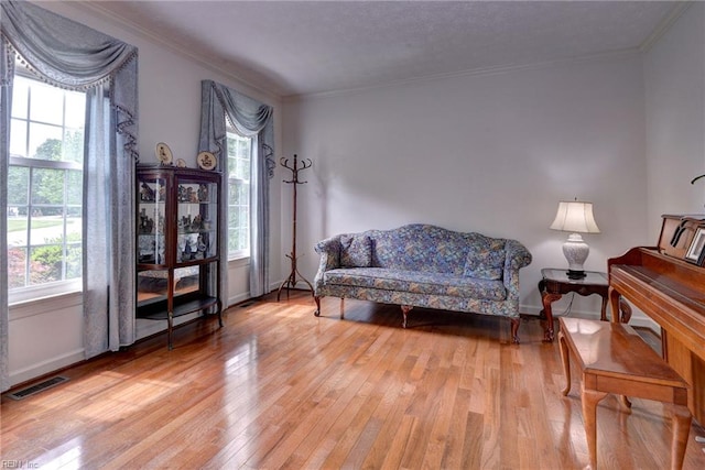 4901 Toddington Cir, Williamsburg, VA 23188 - living area featuring plenty of natural light, light wood-type flooring, crown molding, and baseboards
