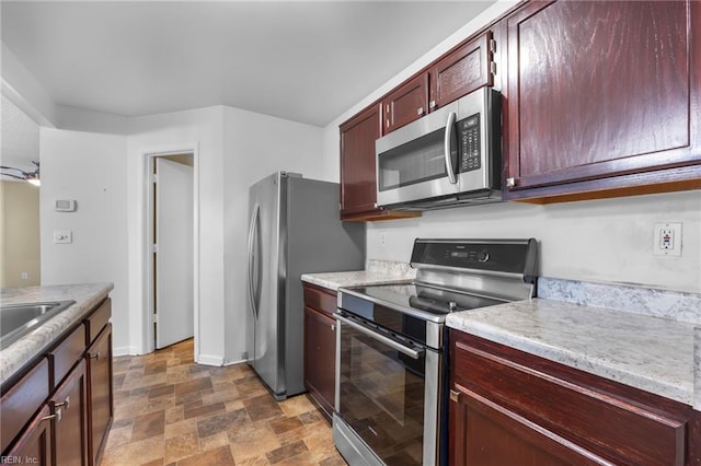 5217 Bardith Cir, Virginia Beach, VA 23455 - kitchen featuring stainless steel appliances, stone finish floors, dark brown cabinets, and light countertops