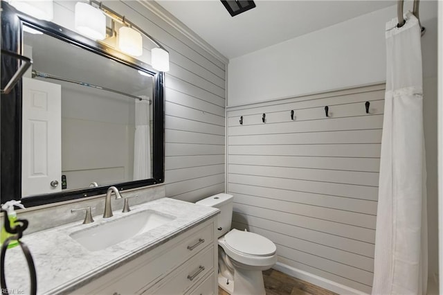 725 Forest Trl, Virginia Beach, VA 23452 - bathroom with wood walls, wood finished floors, toilet, vanity, and a shower with curtain