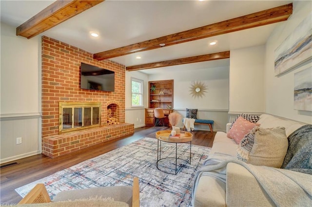 1305 Oak Ridge Dr, Chesapeake, VA 23322 - living room featuring wood finished floors, beamed ceiling, a wainscoted wall, recessed lighting, and a fireplace