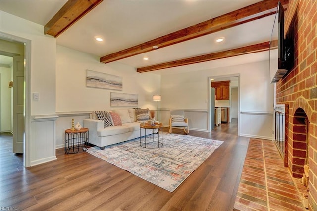 1305 Oak Ridge Dr, Chesapeake, VA 23322 - living area with beam ceiling, wood finished floors, a fireplace, recessed lighting, and wainscoting