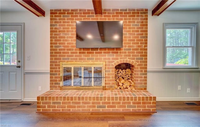 1305 Oak Ridge Dr, Chesapeake, VA 23322 - detailed view of beam ceiling, wood finished floors, a brick fireplace, baseboards, and a wainscoted wall
