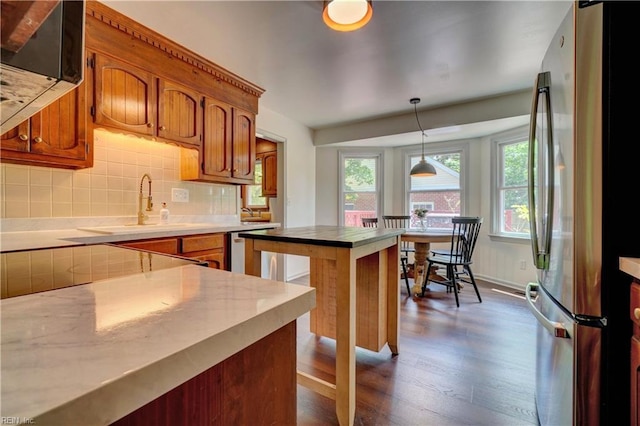 1305 Oak Ridge Dr, Chesapeake, VA 23322 - kitchen featuring freestanding refrigerator, dark wood-style floors, brown cabinets, and tasteful backsplash