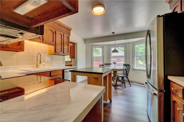1305 Oak Ridge Dr, Chesapeake, VA 23322 - kitchen featuring appliances with stainless steel finishes, dark wood finished floors, tasteful backsplash, brown cabinetry, and light countertops