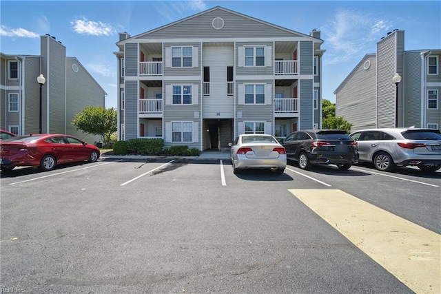view of building exterior featuring uncovered parking