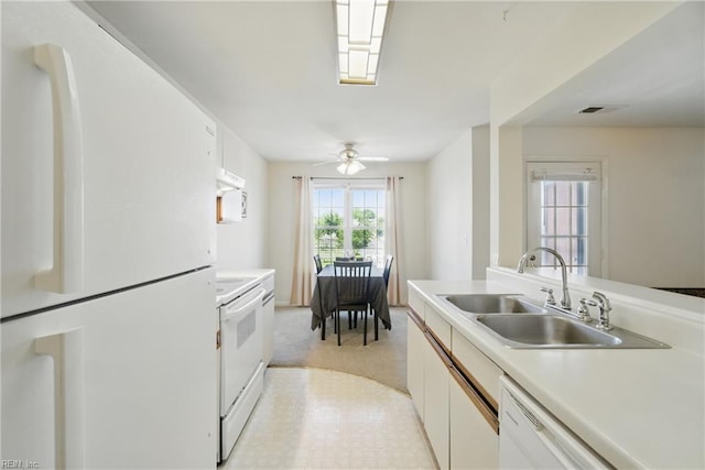 kitchen featuring white appliances, a sink, white cabinets, and light countertops