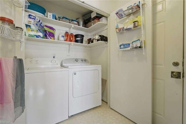 washroom featuring light floors and washer and clothes dryer