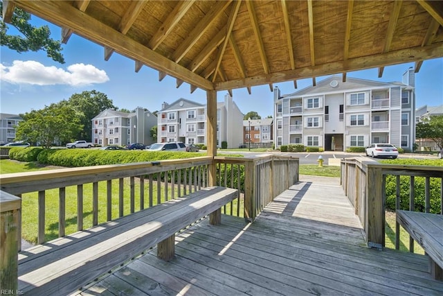 wooden deck featuring a residential view and a lawn