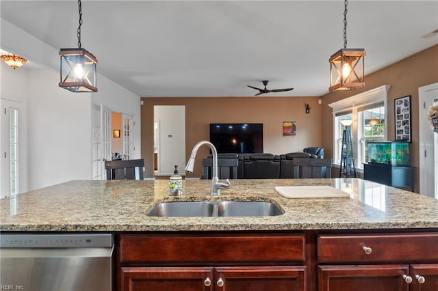 121 Algonquin Trl, Shawboro, NC 27973 - kitchen featuring dishwasher, a sink, reddish brown cabinets, and open floor plan