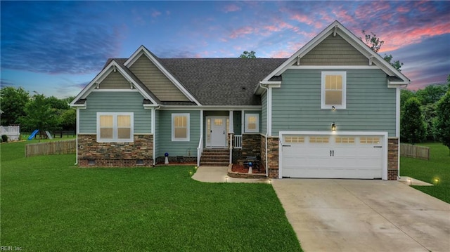 121 Algonquin Trl, Shawboro, NC 27973 - view of front of home featuring an attached garage, concrete driveway, a lawn, and stone siding