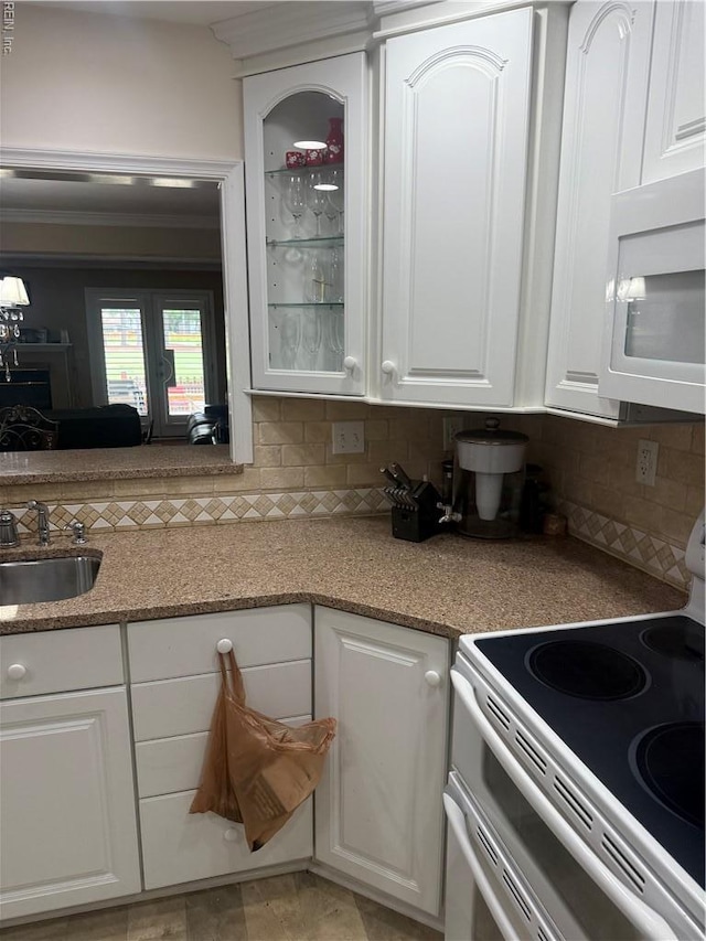 4705 Kempsville Green Parkway, Virginia Beach, VA 23462 - kitchen featuring electric range oven, white microwave, a sink, white cabinets, and decorative backsplash