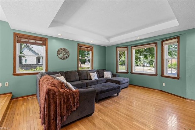 2740 Duckwood Ct, Suffolk, VA 23435 - living room featuring a tray ceiling, baseboards, light wood-style floors, plenty of natural light, and recessed lighting
