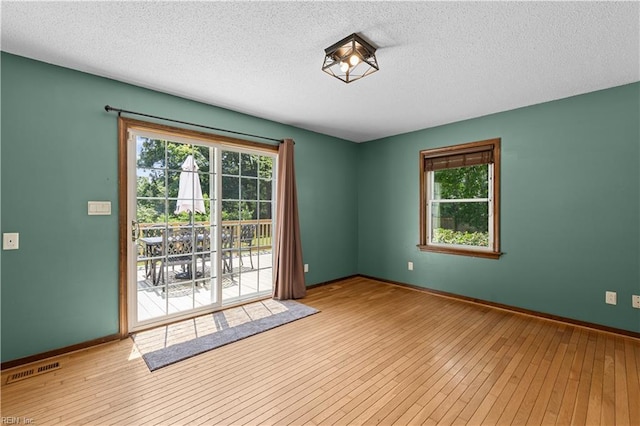 2740 Duckwood Ct, Suffolk, VA 23435 - empty room with hardwood / wood-style floors, a textured ceiling, and baseboards