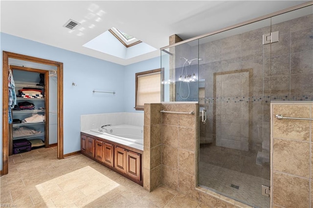 2740 Duckwood Ct, Suffolk, VA 23435 - bathroom with a skylight, a garden tub, a shower stall, and a spacious closet