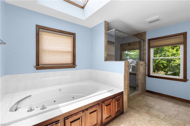 2740 Duckwood Ct, Suffolk, VA 23435 - bathroom featuring a shower stall, a whirlpool tub, a skylight, and baseboards