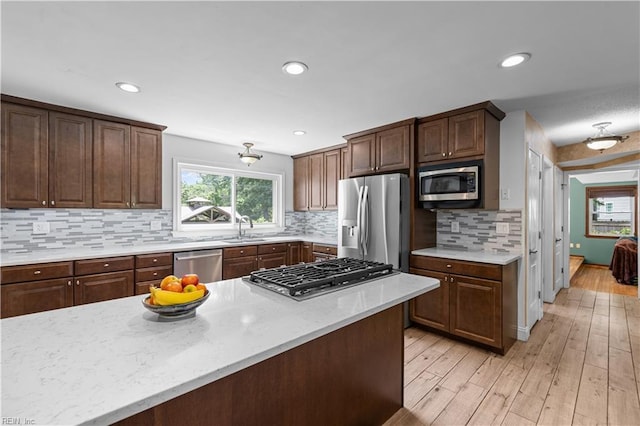 2740 Duckwood Ct, Suffolk, VA 23435 - kitchen with appliances with stainless steel finishes, a sink, light wood finished floors, tasteful backsplash, and recessed lighting