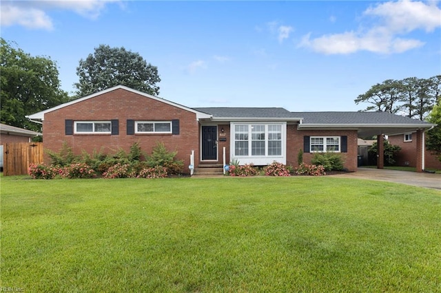 ranch-style house with brick siding, concrete driveway, and an attached carport