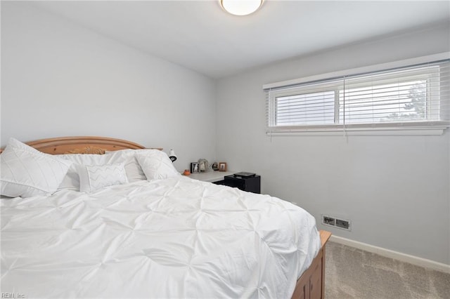 bedroom with carpet and baseboards
