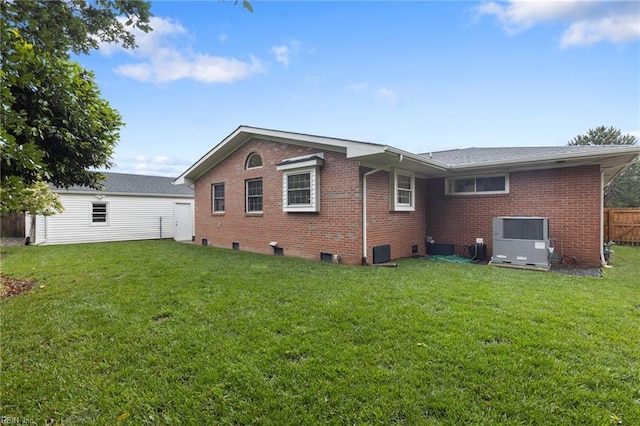 rear view of property with brick siding and cooling unit