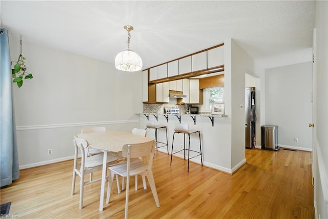 411 Rhode Island Ave, Norfolk, VA 23508 - dining room featuring light wood-type flooring, a chandelier, and baseboards