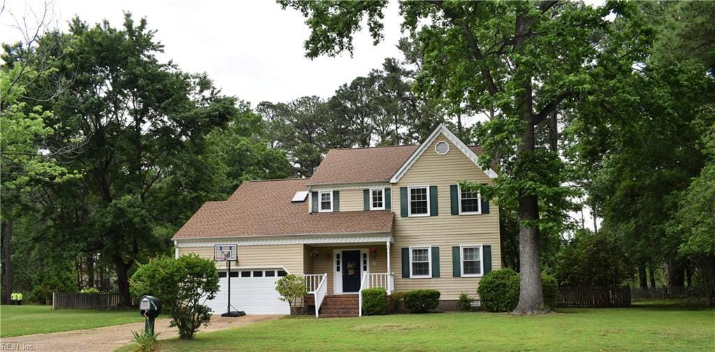 10 Thomas Dr, Poquoson, VA 23662 - view of front of home with an attached garage, view of scattered trees, and driveway