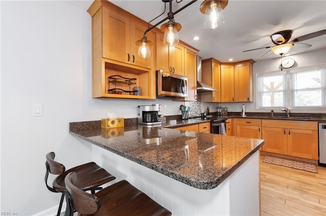 216 Stubbs Dr, Chesapeake, VA 23323 - kitchen with stainless steel appliances, a sink, a peninsula, dark stone counters, and a breakfast bar area