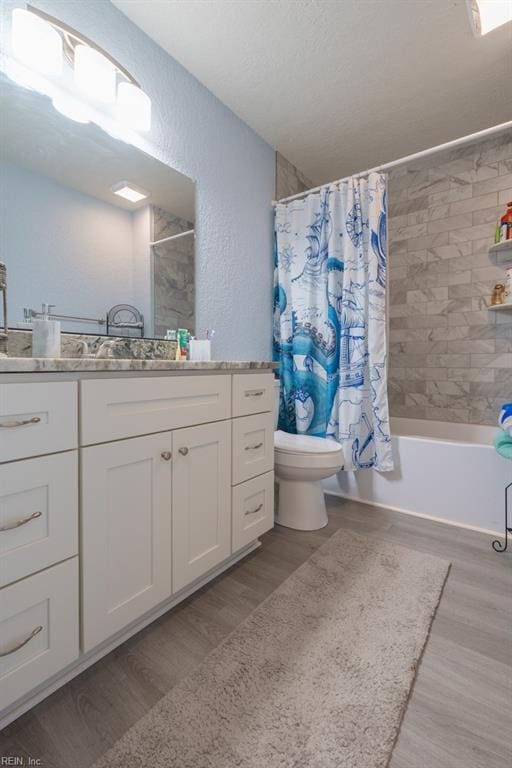 310 Manteo Ave, Hampton, VA 23661 - bathroom featuring wood finished floors, toilet, shower / tub combo, vanity, and a textured wall