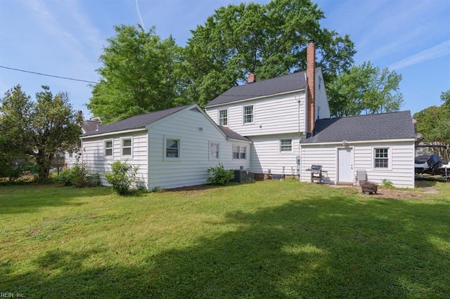 310 Manteo Ave, Hampton, VA 23661 - rear view of house with a yard, a chimney, and central AC unit